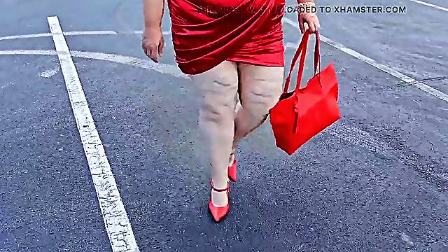 Gorgeous woman walking outdoors in public parking lot showing off for strangers